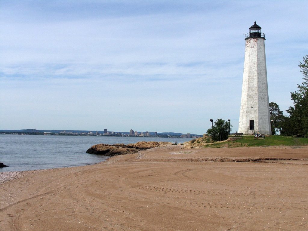 Five Mile Point Light, a brownstone lighthouse tower, at Lighthouse Point Park