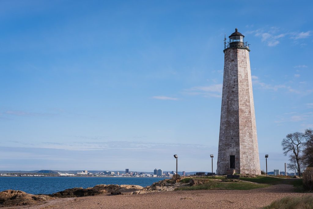 Five Mile Point Light at Lighthouse Point, with the New Haven skyline across the harbor