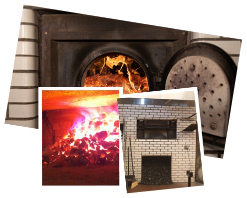 Frank Pepe’s coal-fired brick oven, with the firebox glowing and pizza peels nearby