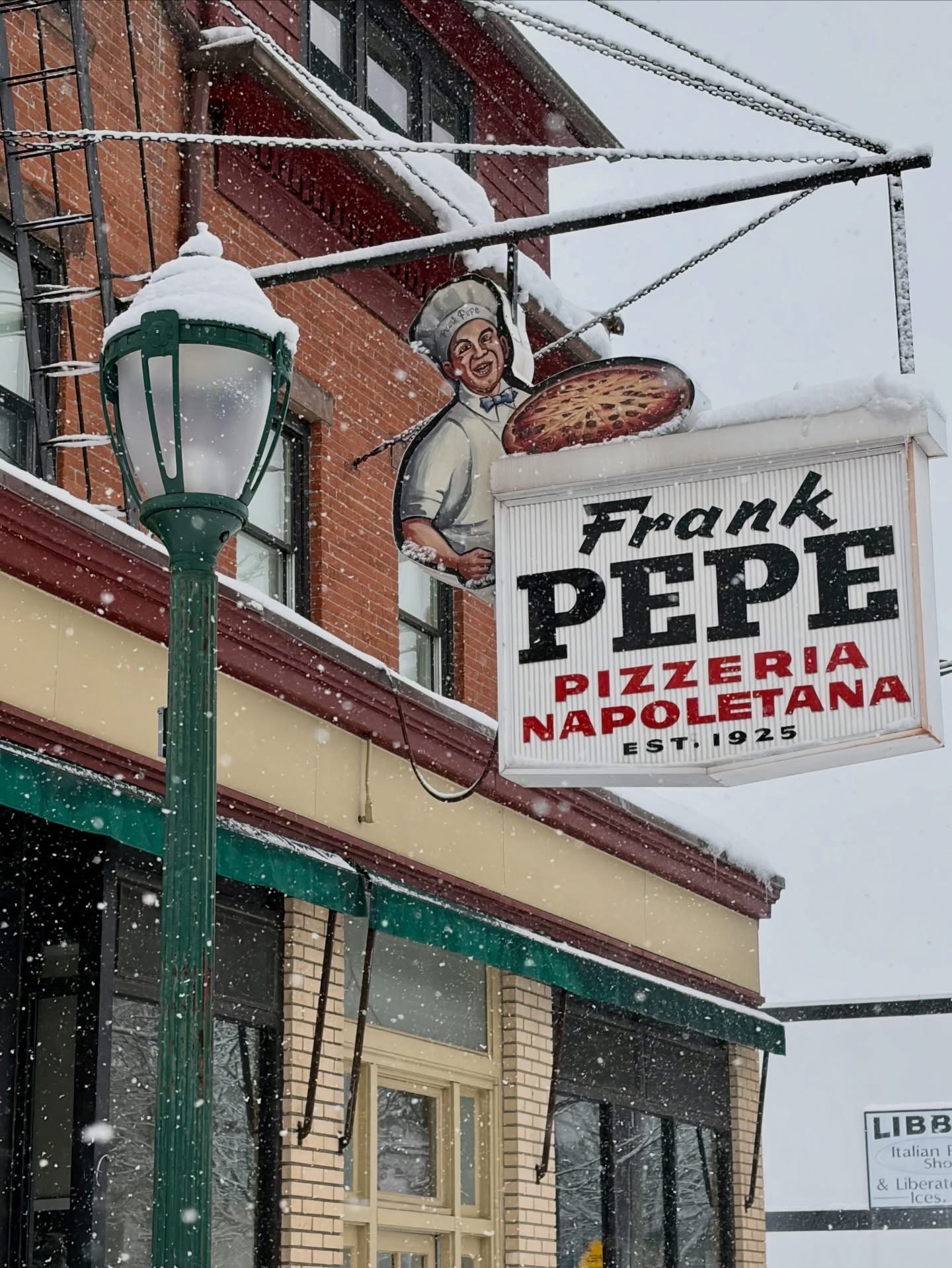 The Frank Pepe Pizzeria Napoletana hanging sign on Wooster Street in New Haven