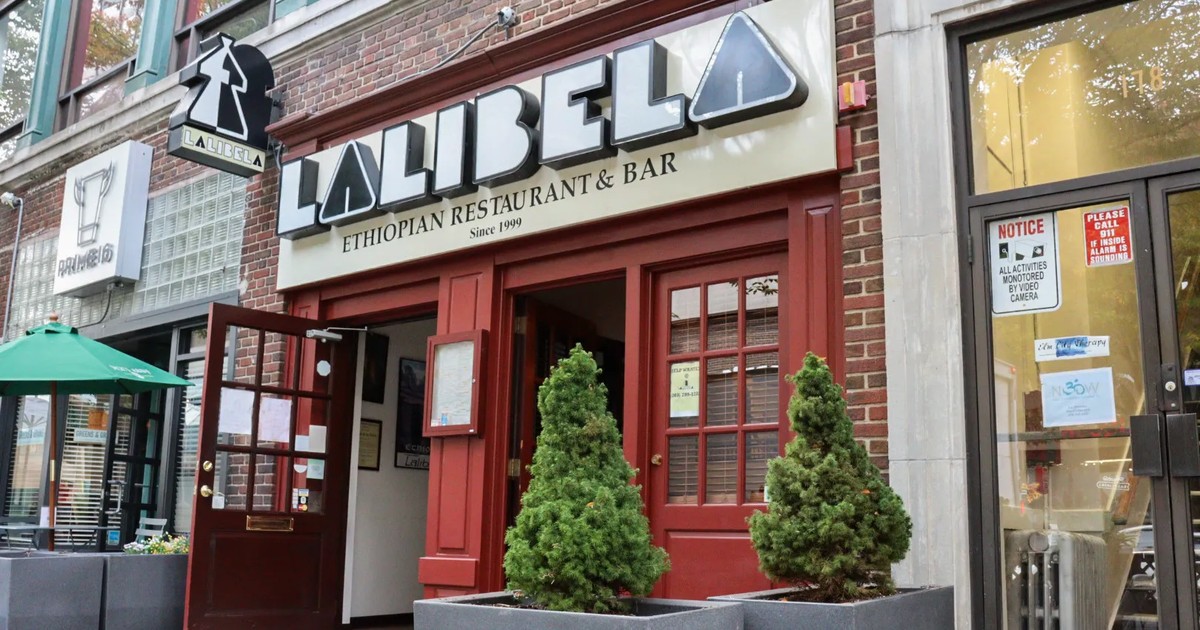 The Lalibela Ethiopian Restaurant & Bar storefront at 176 Temple St. in New Haven, with red doors, potted evergreens and a sign reading Since 1999