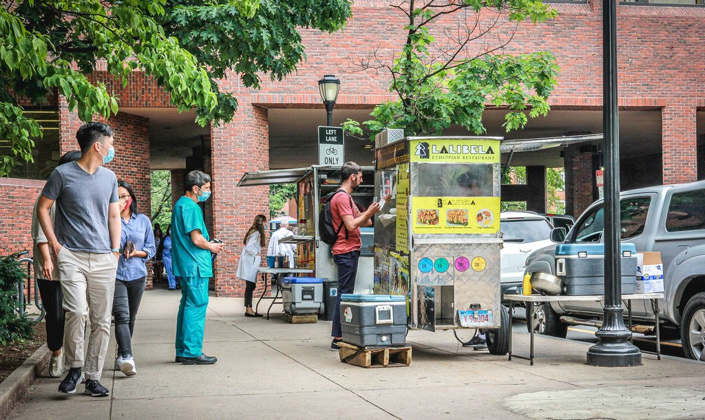 Customers at a Lalibela food cart on a New Haven sidewalk at lunchtime