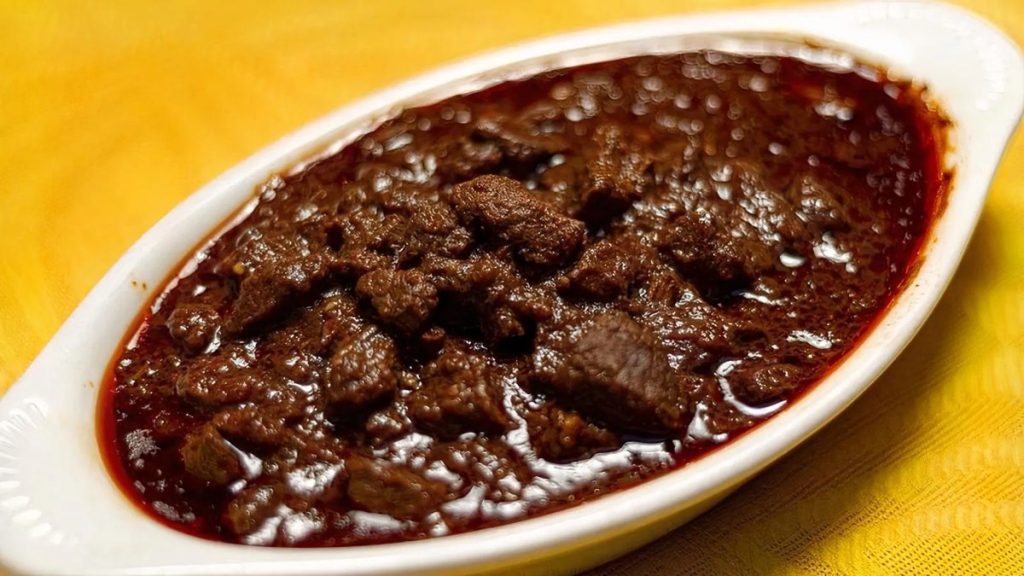 Lalibela’s siga wat, cubed beef in a dark, glossy berbere stew in a white oval dish