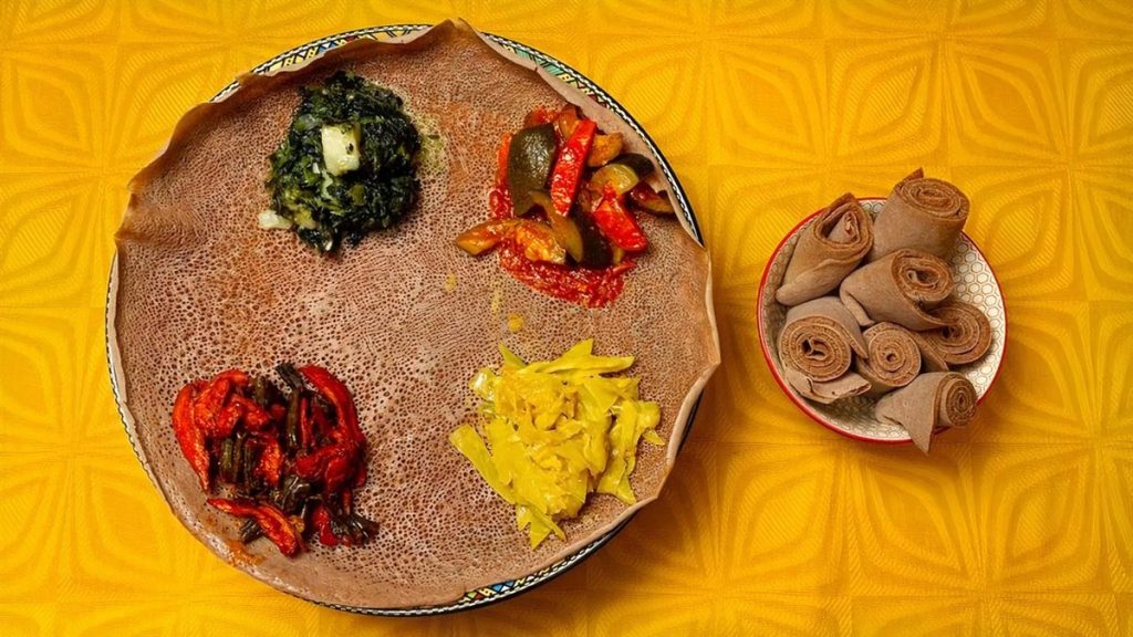 Lalibela’s vegetarian combo, four vegetable dishes arranged on a round of injera with rolled injera on the side
