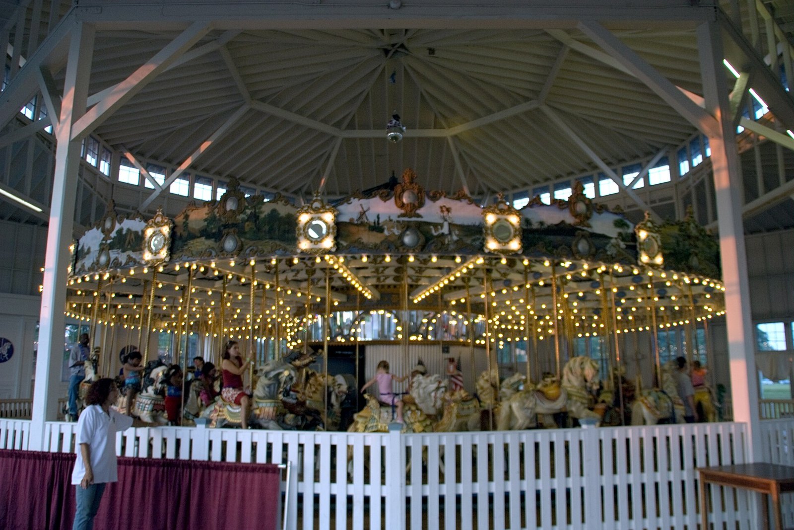 The Lighthouse Point Carousel in Morris Cove, with carved horses and a painted canopy