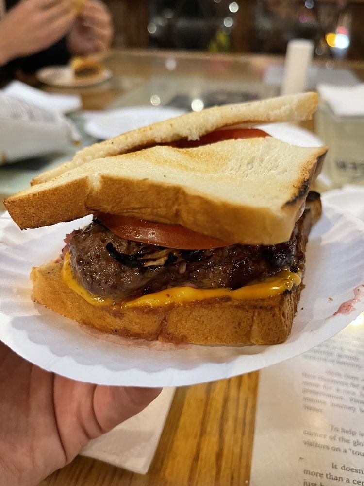 A Louis’ Lunch cheeseburger with tomato on white toast