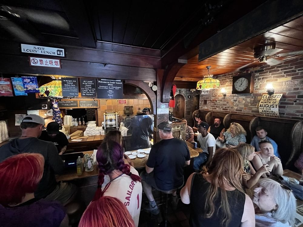 A packed crowd of customers inside Louis’ Lunch