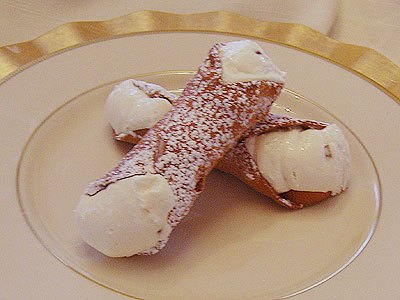 Two Sicilian cannoli filled with ricotta and chocolate chips at Lucibello’s