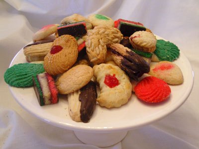 An assortment of Italian cookies including rainbow cookies and jam sandwich cookies