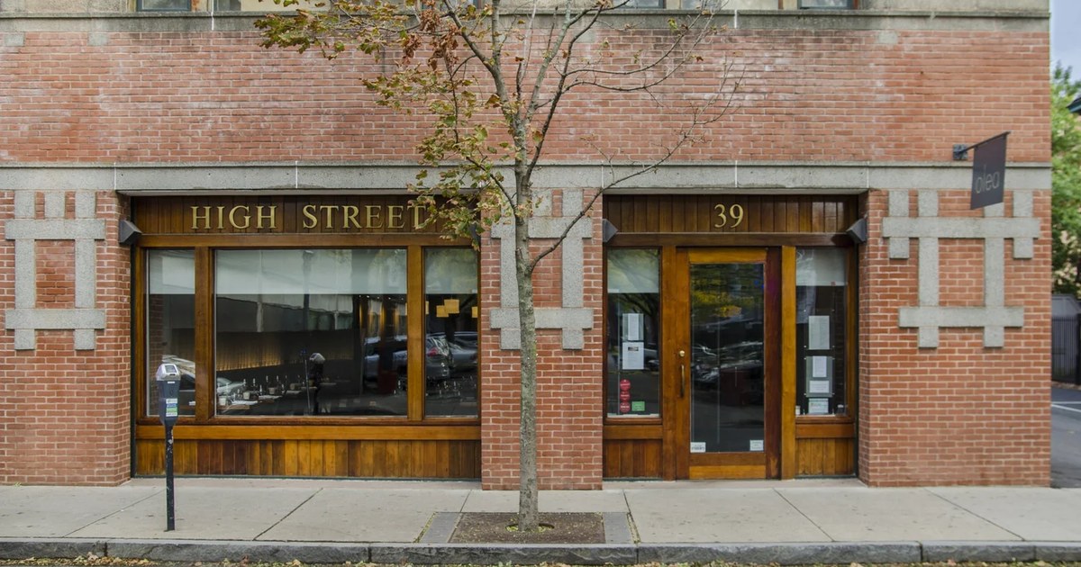 The Olea storefront at 39 High St. in New Haven, with wood-framed windows and the small Olea sign