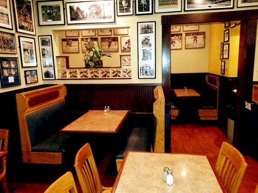 The dining room at Yorkside Pizza, with booths and framed photos on every wall