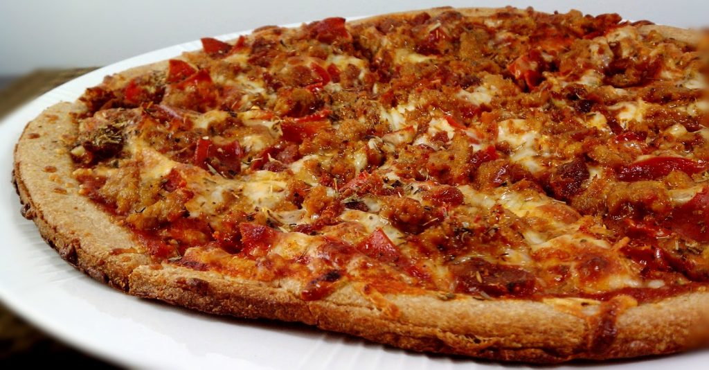 A whole pizza from Yorkside Pizza on a white plate