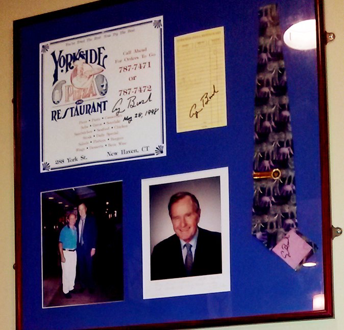 A framed Yorkside menu and guest check signed G Bush, dated May 28, 1998, with a presidential portrait and a tie