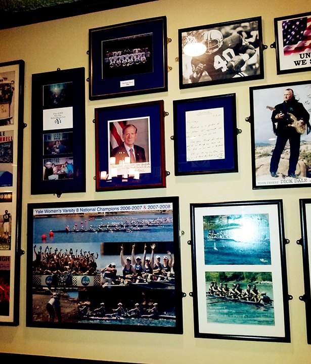 Framed Yale crew and sports photos on the wall at Yorkside Pizza