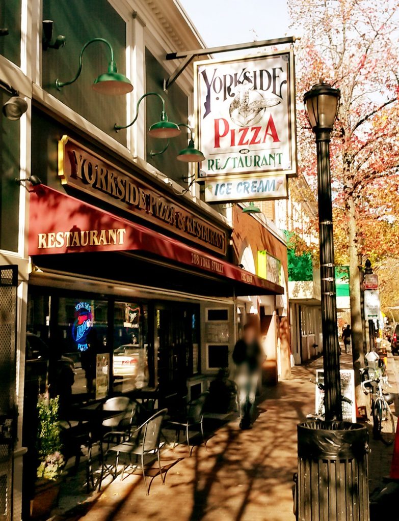 Yorkside Pizza’s hanging sign and red awning on York Street in New Haven