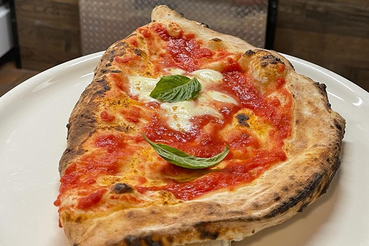 A Calzone Napoletano cut open to show the ricotta and mozzarella filling
