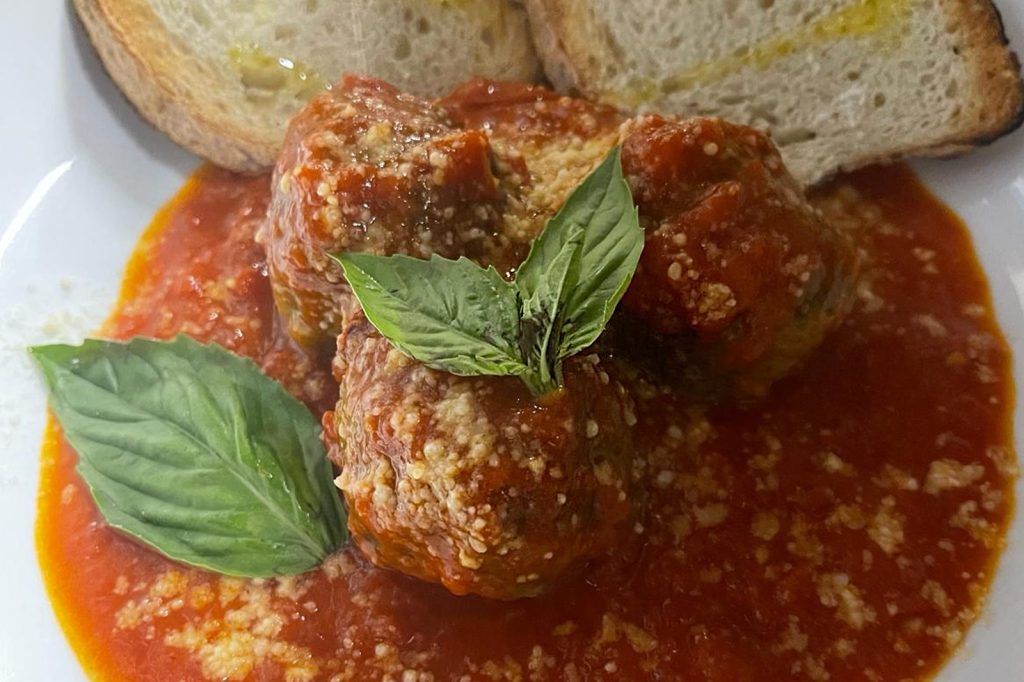 Homemade Italian meatballs in San Marzano tomato sauce with toasted bread